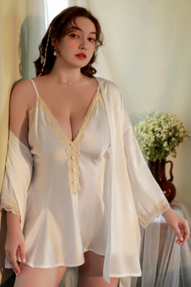 Plus size model wearing a white plus size sexy nightgown with V-neck lace detail and sheer robe, suitable for nightwear and bridal-inspired collections.