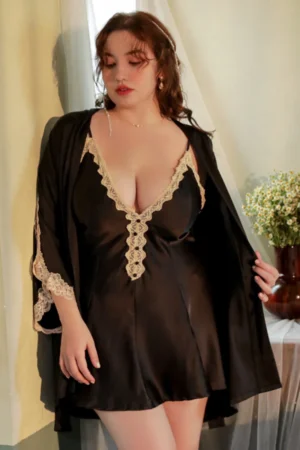 Model wearing a black plus size sexy nightgown with lace-trimmed neckline and sleeves, paired with a lightweight robe, designed for comfortable and flattering fit.