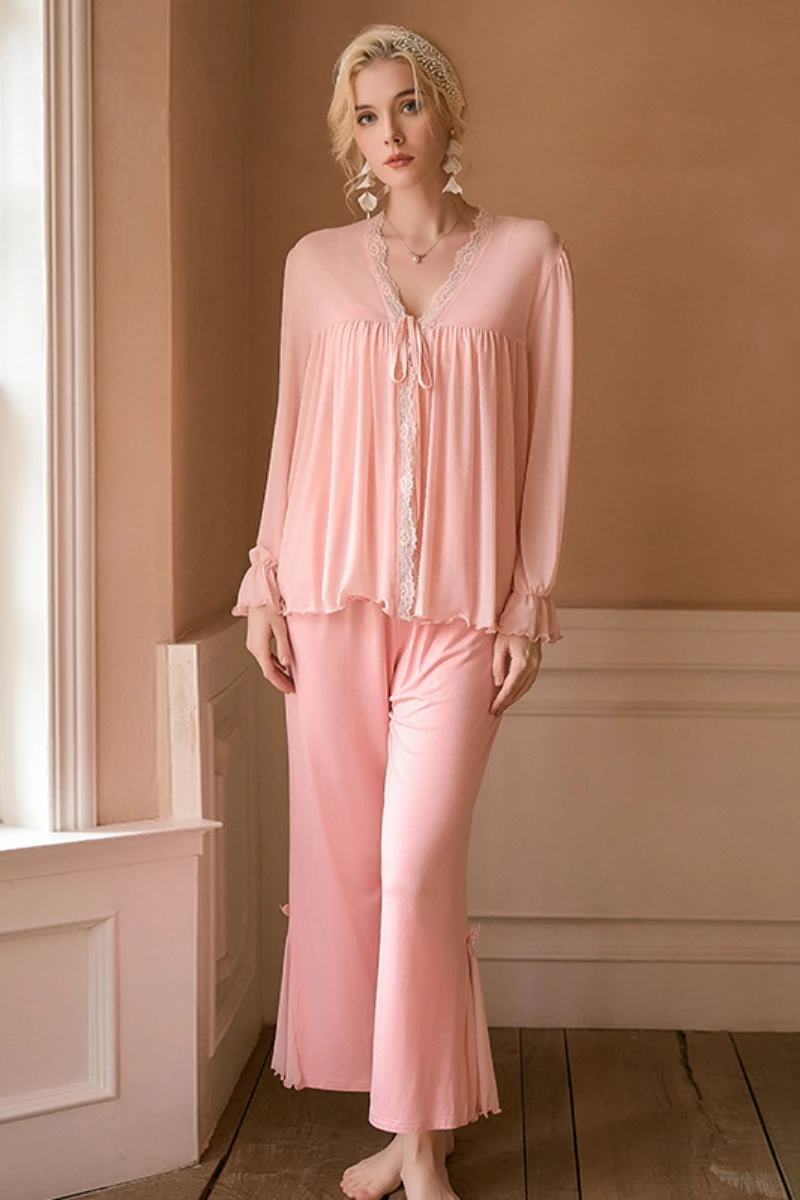 Model wearing a soft pink cotton two-piece pajama set with lace-trimmed top and relaxed pants, designed as a private label cotton sexy nightgown option for B2B supply.