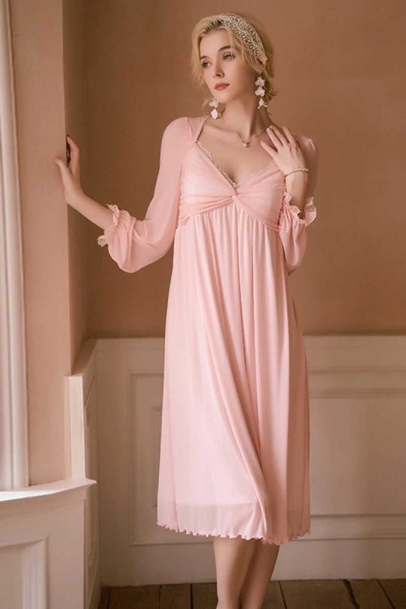 Model wearing a soft pink sheer long nightgown with lace-trimmed neckline and flowing silhouette, designed for private label nightgowns sexy collections.
