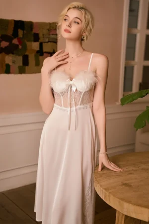 Model wearing private label sexy long nightgowns in light beige, featuring a lace bodice, feather trim detail, and flowing long skirt