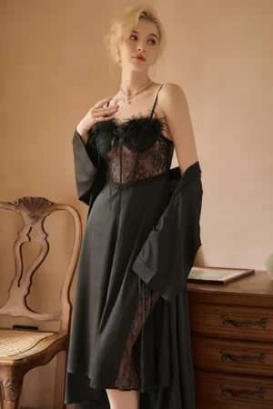 Model wearing black private label women sexy nightgowns featuring sheer lace bodice, feather trim neckline, open back design, and flowing long skirt with matching robe.