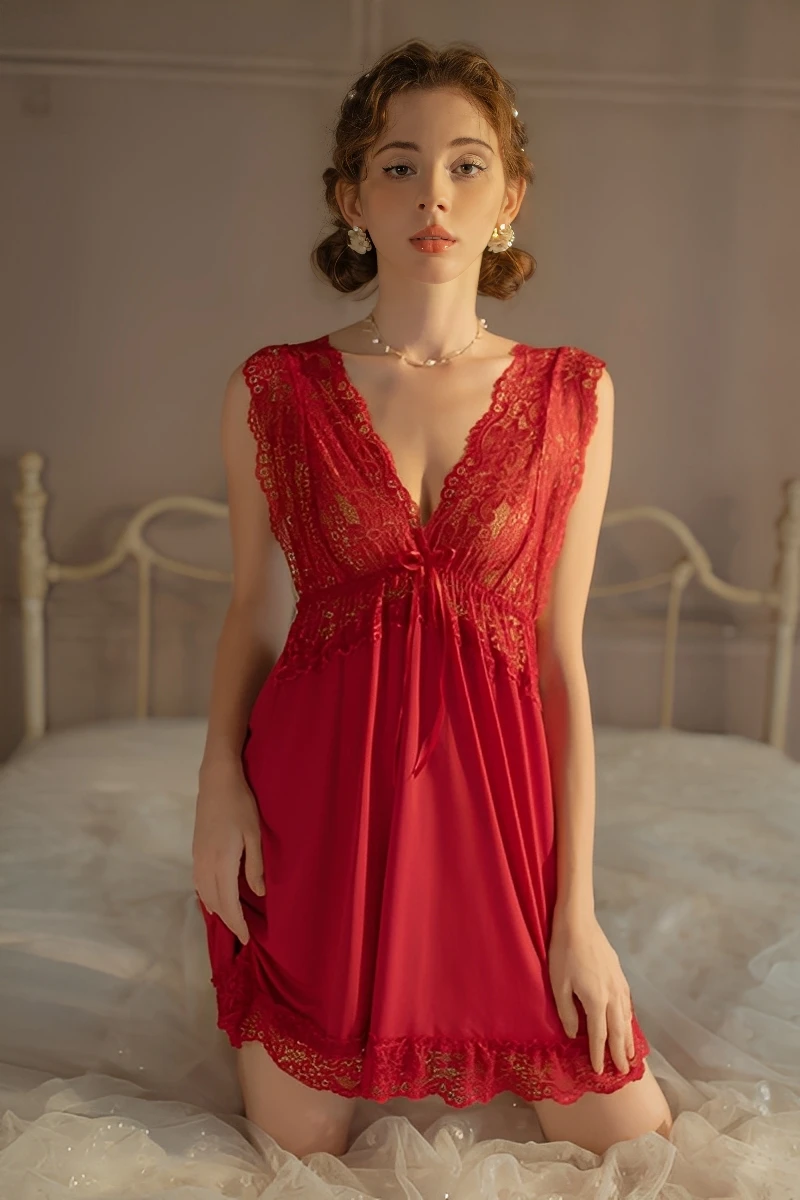 A wine red wholesale lace bridal pajamas nightgown with gorgeous lace detailing on the chest and hem, worn by a model near a vintage vanity.