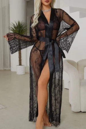 Model wearing a black sexy see through nightgown with transparent lace fabric, deep neckline, long sleeves, and waist sash.