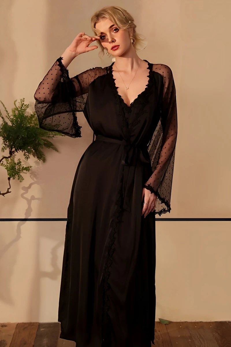 Model in black sexy silk nightgown featuring lace V-neckline, sheer long sleeves, and flowing silk skirt