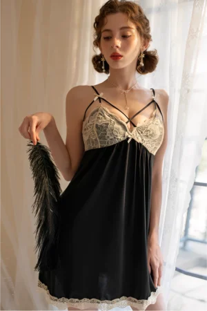 Model wearing wholesale lace pajama set in black with sheer fabric, lace bust panel, and delicate crisscross straps.