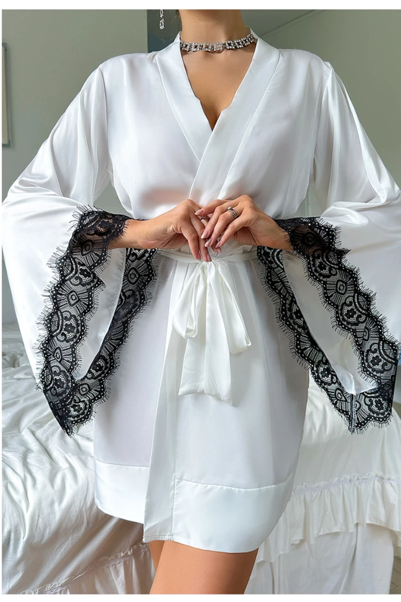 Wholesale lace sexy nightgowns in white satin featuring contrast black lace bell sleeves and a wrap-front tie waist design