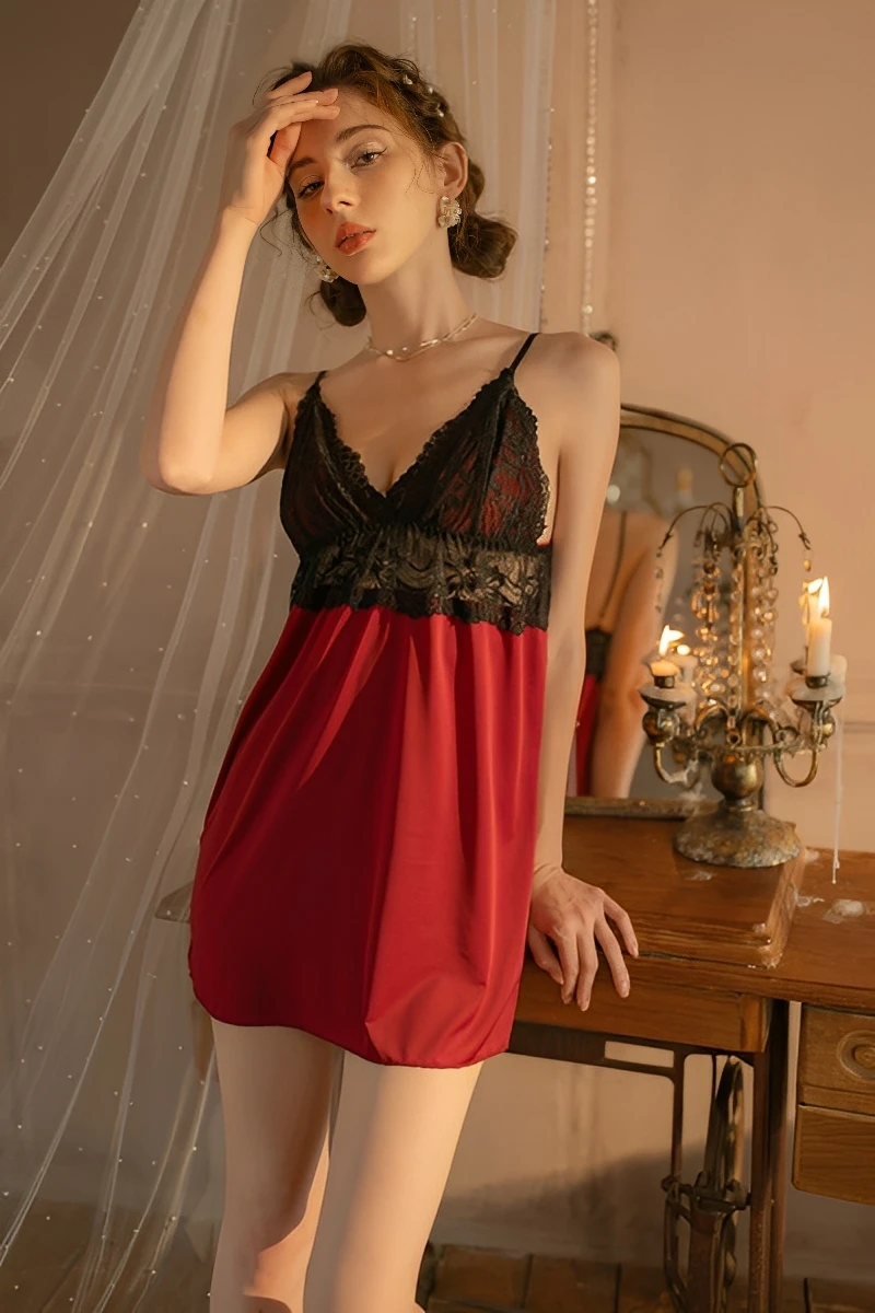 Model wearing a burgundy wholesale satin pajama set laces featuring a soft satin body, lace-trimmed bust, and adjustable spaghetti straps in an elegant bedroom setting.
