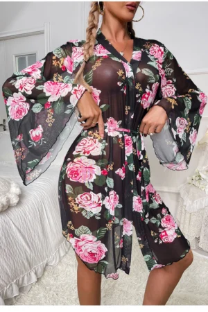 Model wearing a wholesale sexy black nightgown featuring sheer floral mesh fabric, loose kimono-style sleeves, and a waist tie for a seductive silhouette.