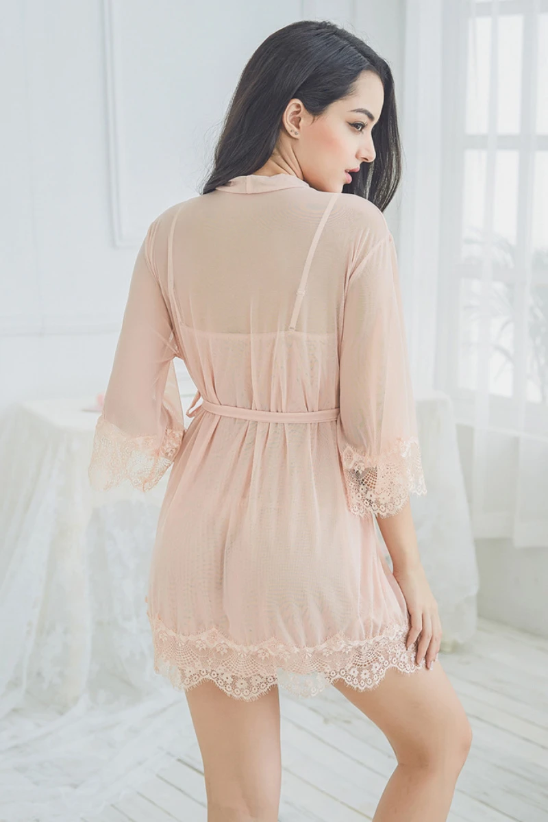 Back view of a blush pink wholesale sexy see through nightgown showing sheer mesh fabric, lace hemline, and relaxed robe fit.