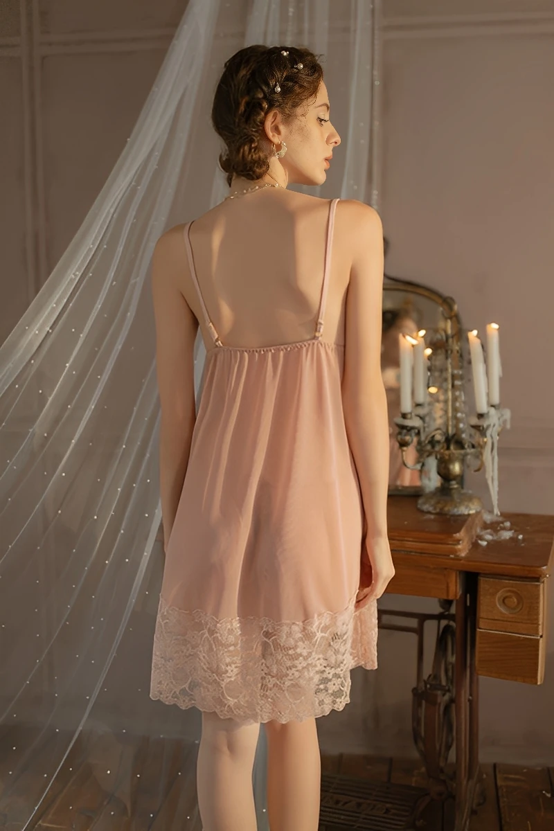 Back view of wholesale silk pajamas with lace showing adjustable straps, smooth silk drape, and lace hem for women’s wholesale nightwear.