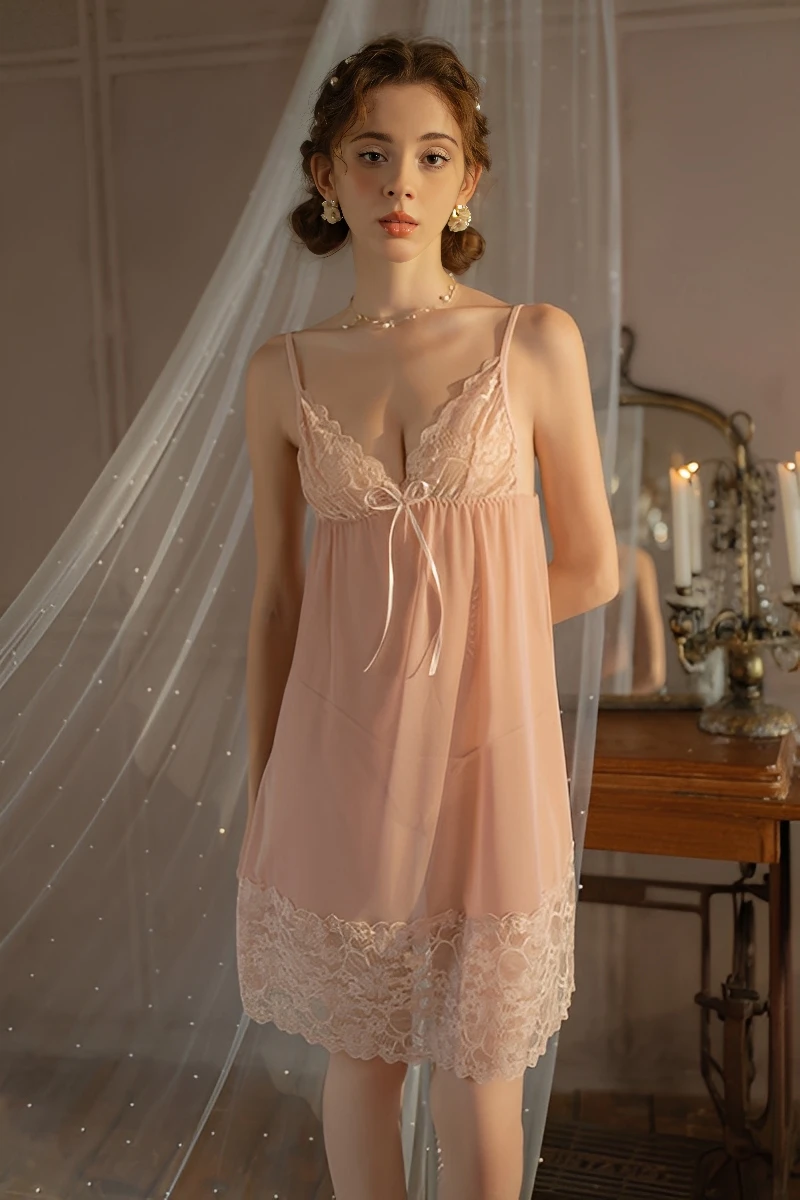 Model wearing wholesale silk pajamas with lace in blush pink, featuring a sheer silk body and delicate lace trim for women’s sleepwear wholesale.