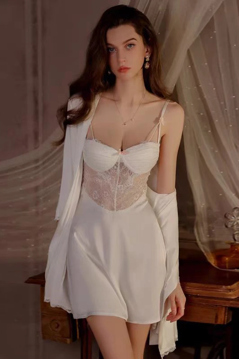 Model wearing a white lace slip and robe set, showcasing a wholesale womens sexy nightgown with sheer lace bodice and soft drape.